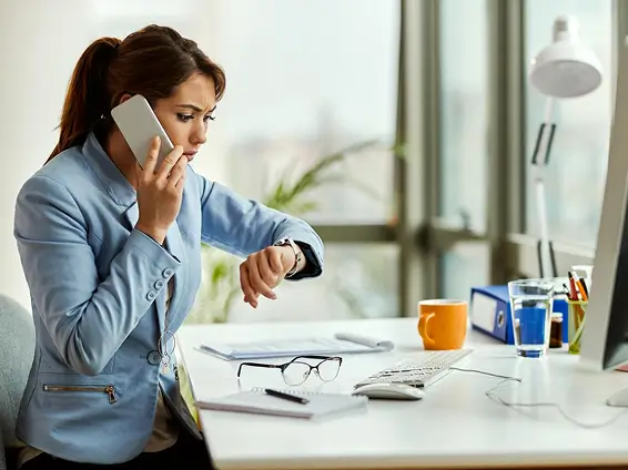 distraught businesswoman talking phone while looking time her wristwatch office 637285 5282 1